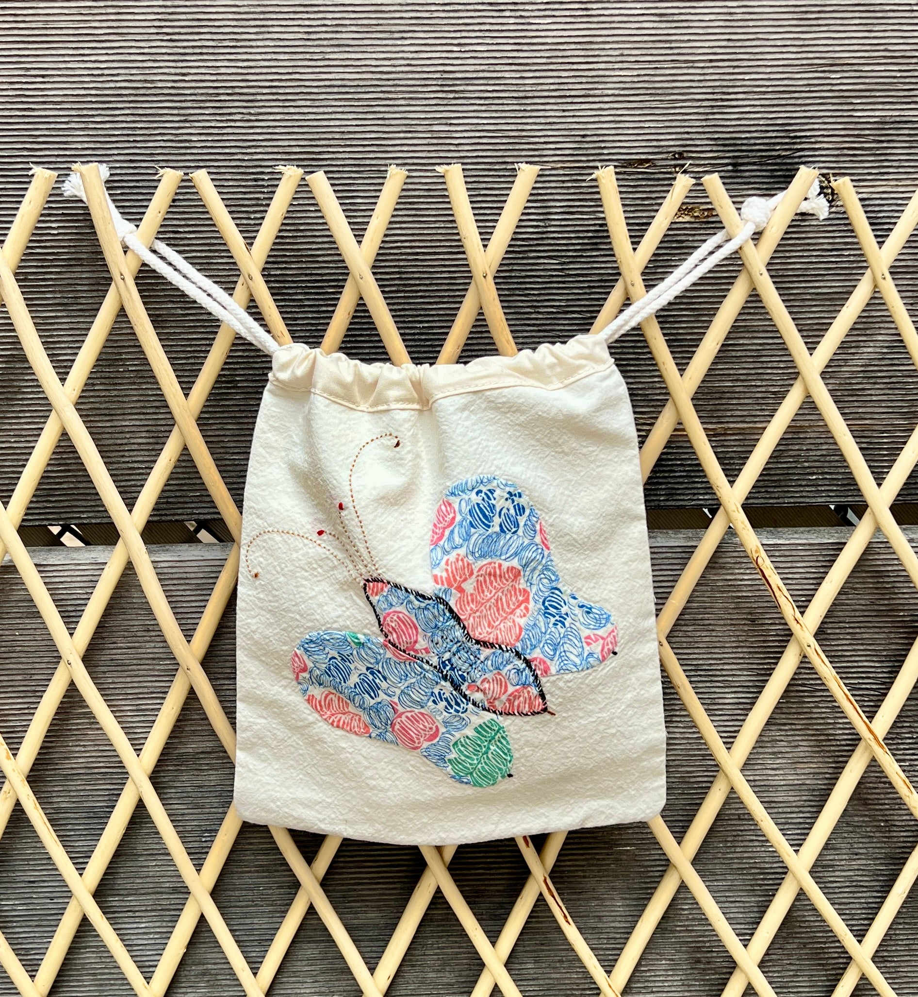 4 Antennae Butterfly Drawstring Bag (Blue/Pink Scribbles & Red Squares)