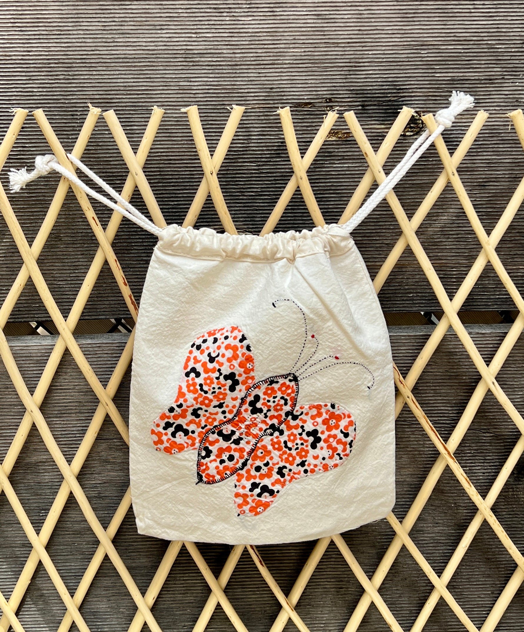 4 Antennae Butterfly Drawstring Bag (Black Swirls & Orange Daisies)