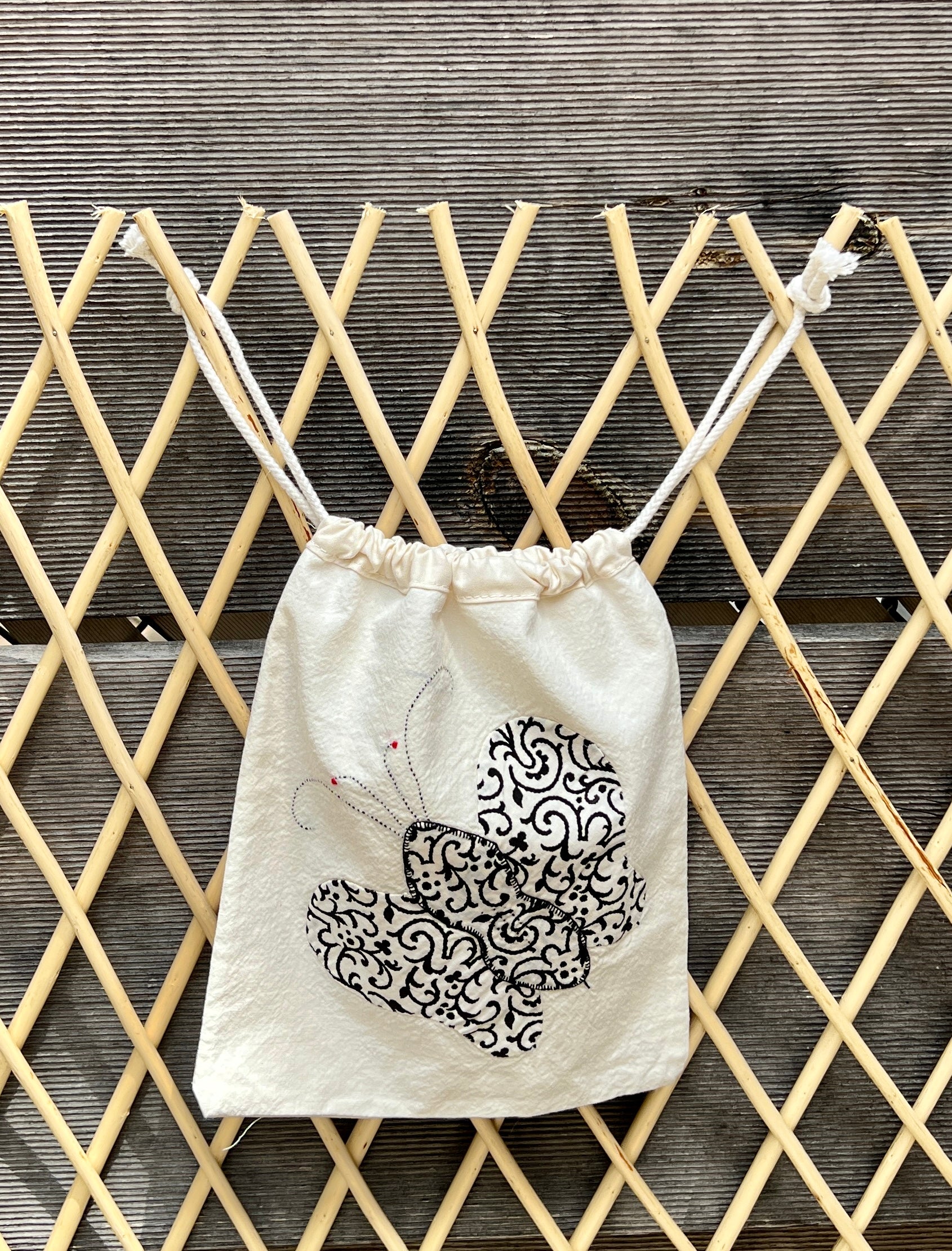 4 Antennae Butterfly Drawstring Bag (Black Swirls & Orange Daisies)