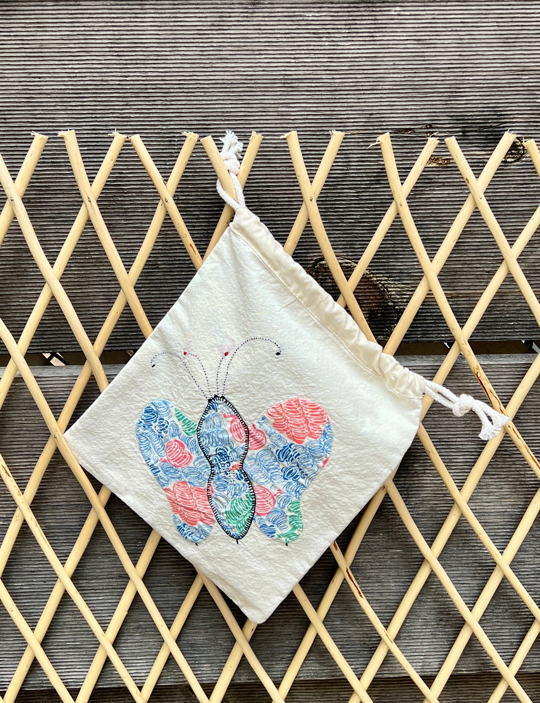 4 Antennae Butterfly Drawstring Bag (Blue/Pink Scribbles & Red Squares)