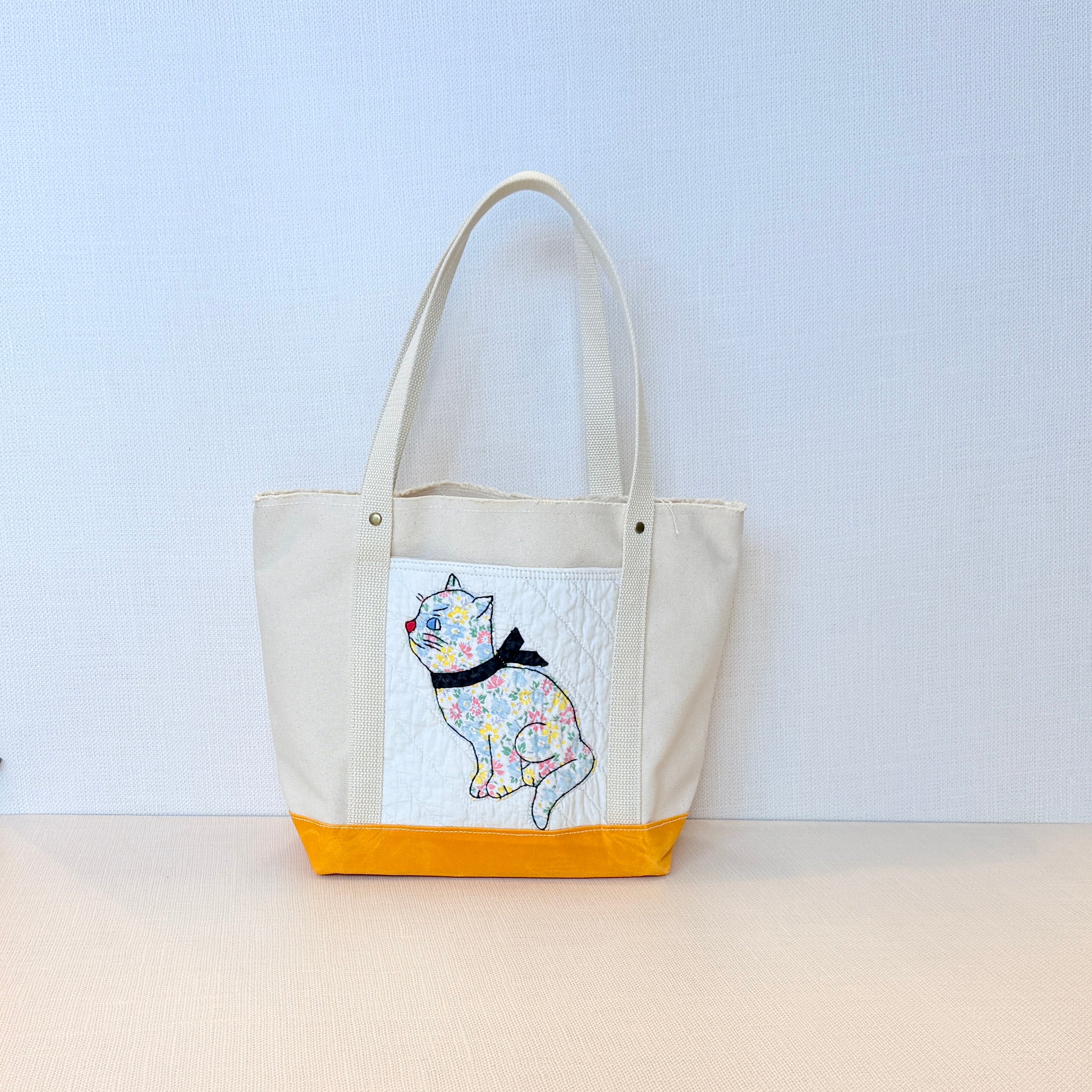 The Skipper Pocket Tote (Yellow/Orange Canvas with Faded Floral Kitten)